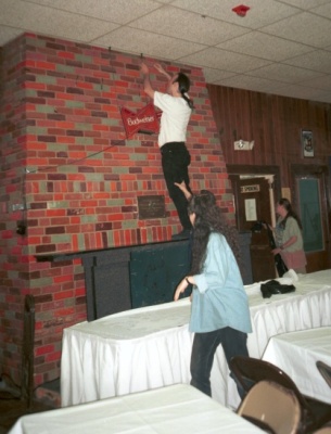 [Steve taking down a beer sign]